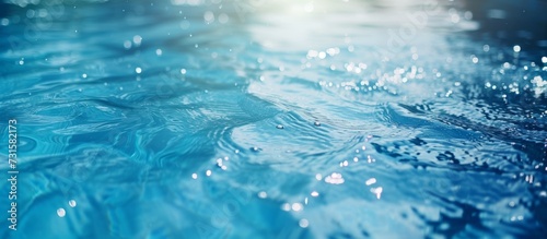 A mesmerizing close-up of liquid azure water with the sun illuminating it, creating a serene natural landscape. © AkuAku