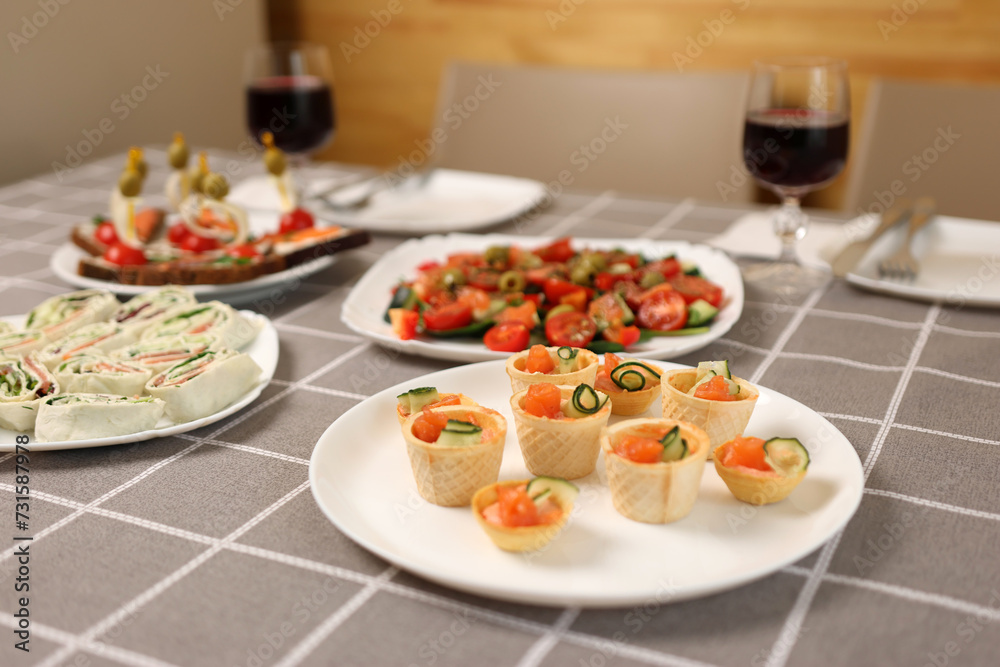 Rolls, vegetable salad, canapés and red wine were served at the festive table.