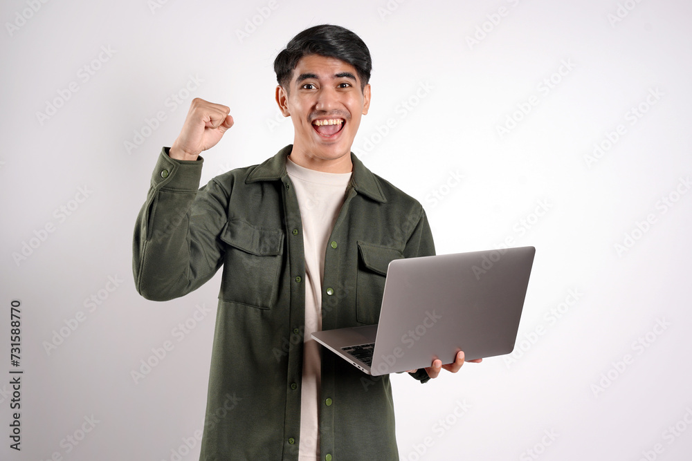 Successful student holding laptop with clenched hands isolated white background. Freelancer Successful student holding laptop with clenched hands isolated white background. Freelancer