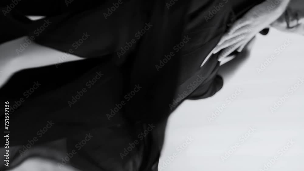 A black and white photo of a woman dancing in a dance studio A black and white photo of a woman dancing in a dance studio