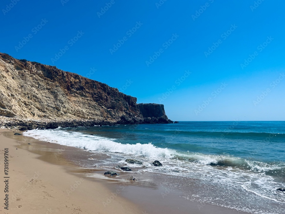 Rocky coast of the ocean bay, clear blue sky, ocean horizon, rocks Rocky coast of the ocean bay, clear blue sky, ocean horizon, rocks