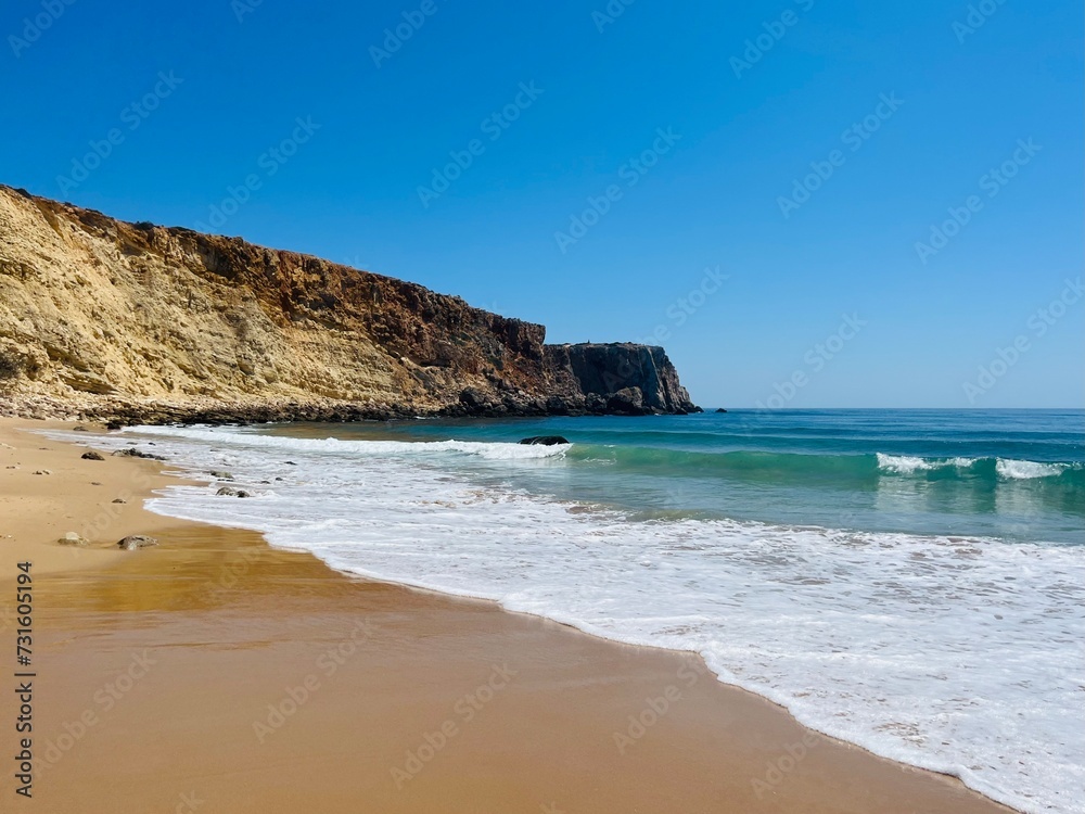 Rocky coast of the ocean bay, clear blue sky, ocean horizon, rocks Rocky coast of the ocean bay, clear blue sky, ocean horizon, rocks