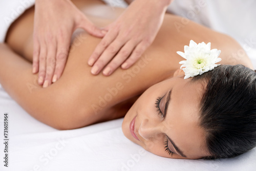 Woman, back massage and beauty treatment for relaxing, wellness and muscle therapy for body care. Female person, masseuse and health by dermatology, calm and resting at resort hotel and peace or zen