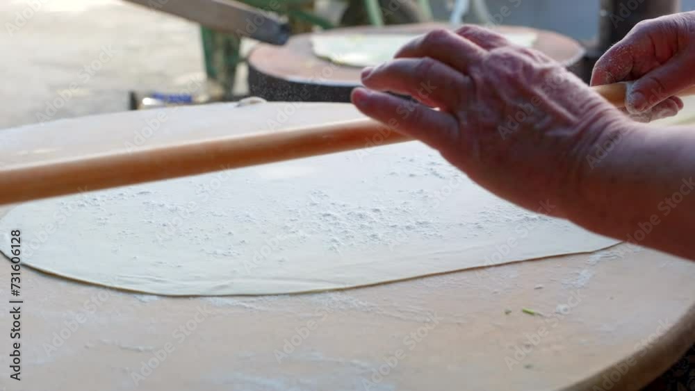 Senior Woman Preparing lavash making with rolling pin. Senior Woman Preparing lavash making with rolling pin.