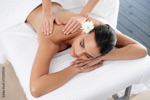 Woman, back massage and body treatment for relaxing, wellness and muscle therapy for bodycare. Female person, masseuse and health by dermatology, calm and resting at resort hotel and peace or zen