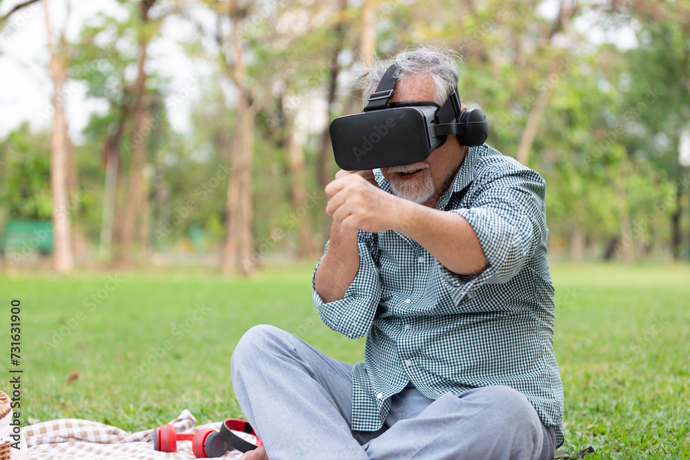 senior man using virtual reality headset(VR) and fighting pose in the park senior man using virtual reality headset(VR) and fighting pose in the park