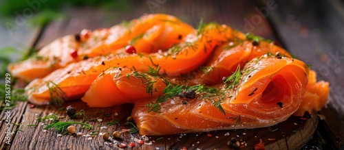 Smoked salmon with dill, made at home, on a wooden table.