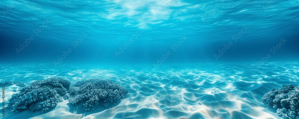 A stunning underwater seascape with coral formations and sunbeams penetrating the ocean's surface