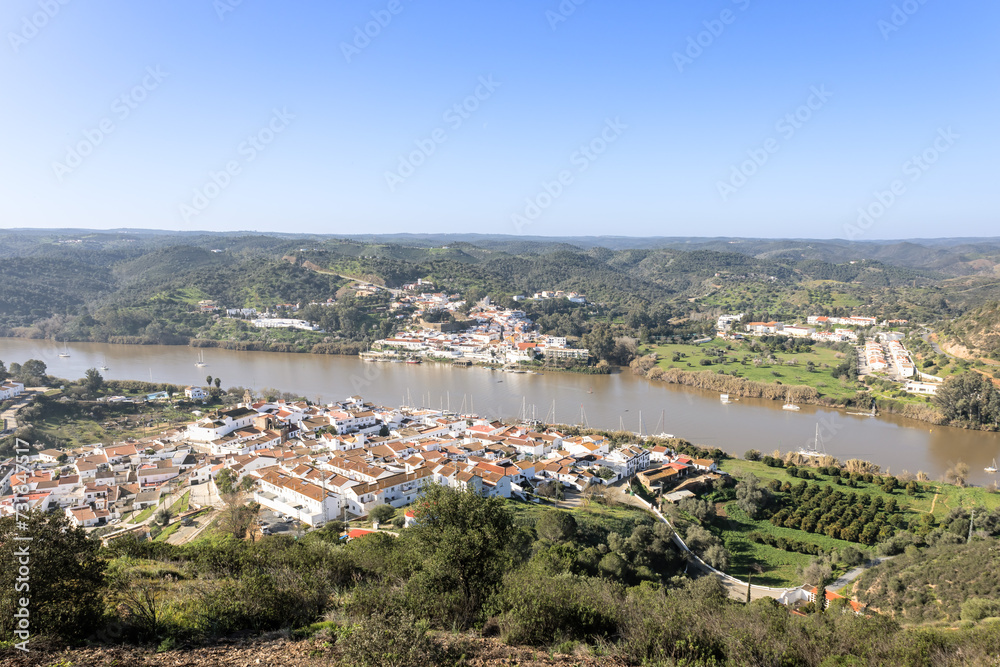 Aerial drone view of Sanlucar de Guadiana village in Huelva, Andalusia, on the banks of Guadiana river, in the border of spain with portugal, in front of the portuguese village of Alcoutim in Algarve