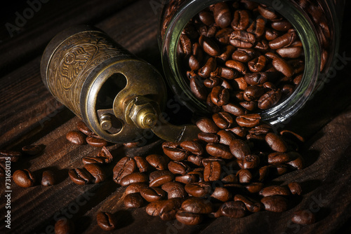 Coffee beans and coffee grinder on the kitchen table close up background. Front view.