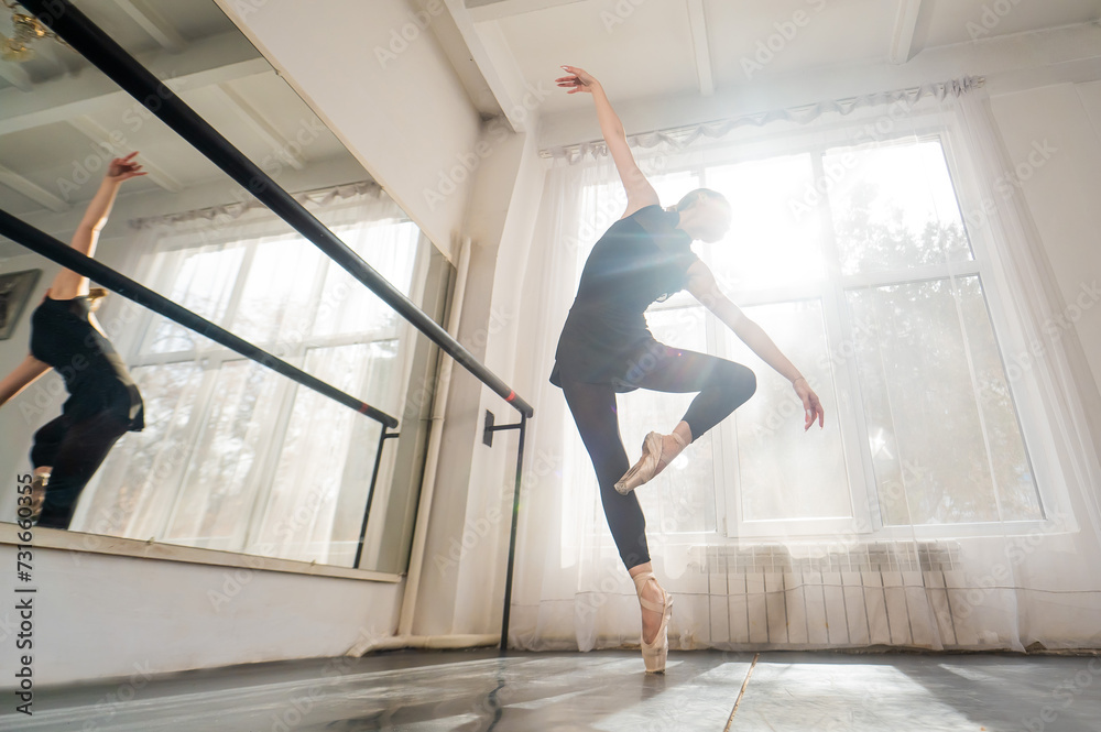 A beautiful Asian woman is dancing at the barre. Ballet dancer. A beautiful Asian woman is dancing at the barre. Ballet dancer.