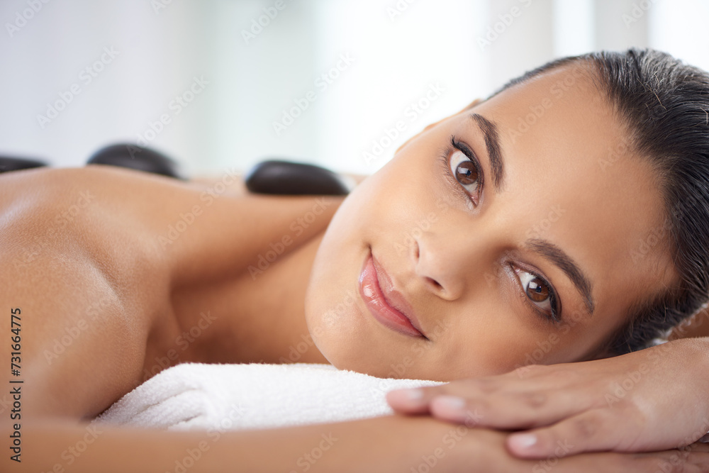 Portrait, hot stone and woman with massage for relaxing at spa for wellness, health and back treatment. Self care, cosmetic and female person with warm stone back therapy at natural beauty salon. Portrait, hot stone and woman with massage for relaxing at spa for wellness, health and back treatment. Self care, cosmetic and female person with warm stone back therapy at natural beauty salon.