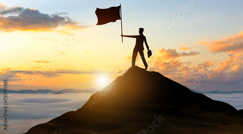 Silhouette businessman with flag climbed to the top of mountain over the sky and sun light background. Success, Achieving goal, Leadership, and Business achievement Concept.