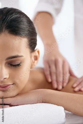 Relax, woman and hands massage shoulder for skincare, beauty and pampering body for wellness at luxury salon. Therapist, table and person at spa for treatment, peace and calm for health with masseuse