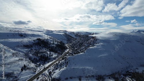 Canvas Print Aerial view of snow covered mountain landscape under blue sky