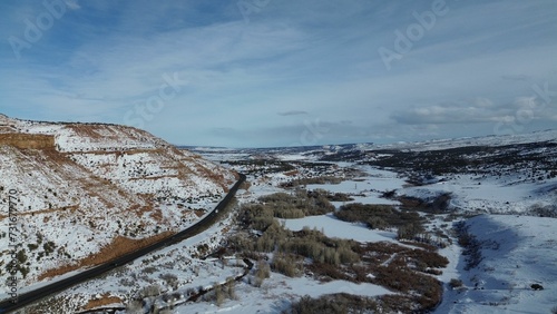 Canvas Print Aerial view of snow covered mountain landscape under blue sky