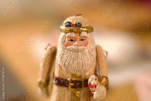 Closeup of an old Santa Clause toy with a striped candy cane