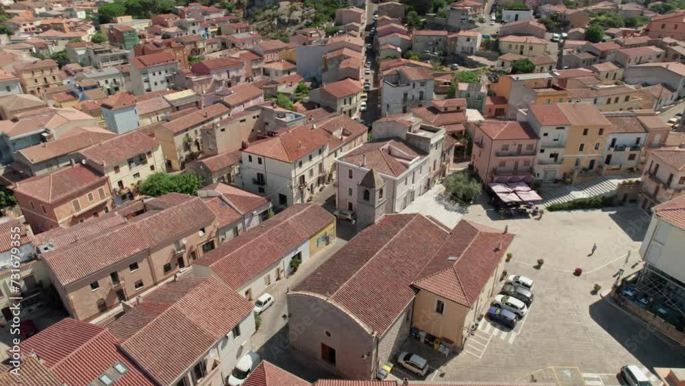 Aerial view of a small medieval church surrounded by brown-roofed buildings in Bosa, Sardinia Aerial view of a small medieval church surrounded by brown-roofed buildings in Bosa, Sardinia