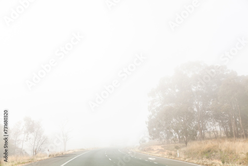 Fog hazardous driving condition with low visibility on road photo
