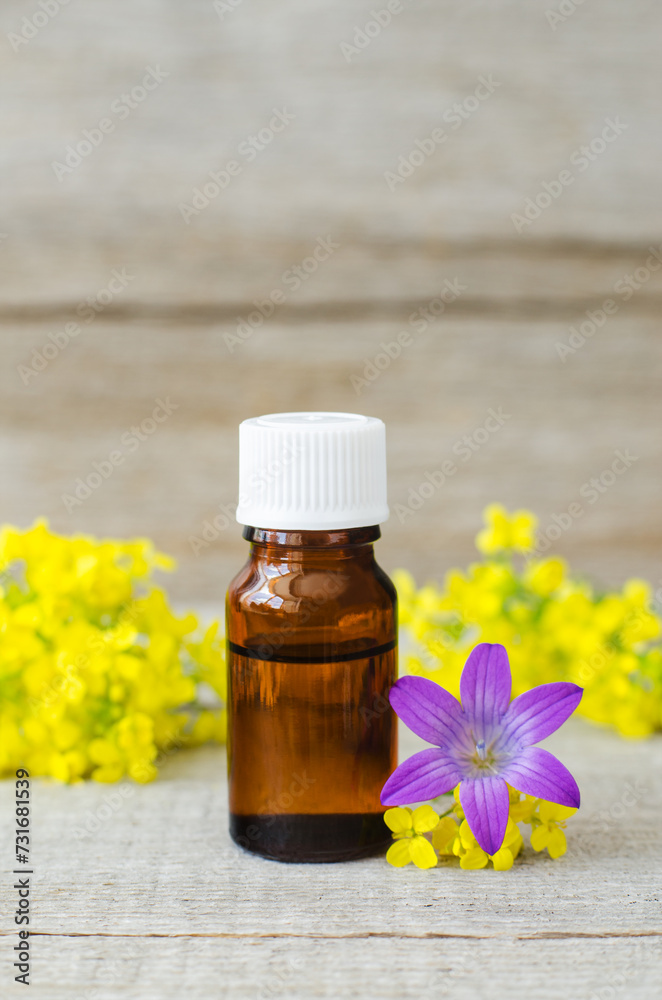 Small bottle with essential oil. Aromatherapy and herbal medicine concept. Old wooden background. Copy space. Small bottle with essential oil. Aromatherapy and herbal medicine concept. Old wooden background. Copy space.