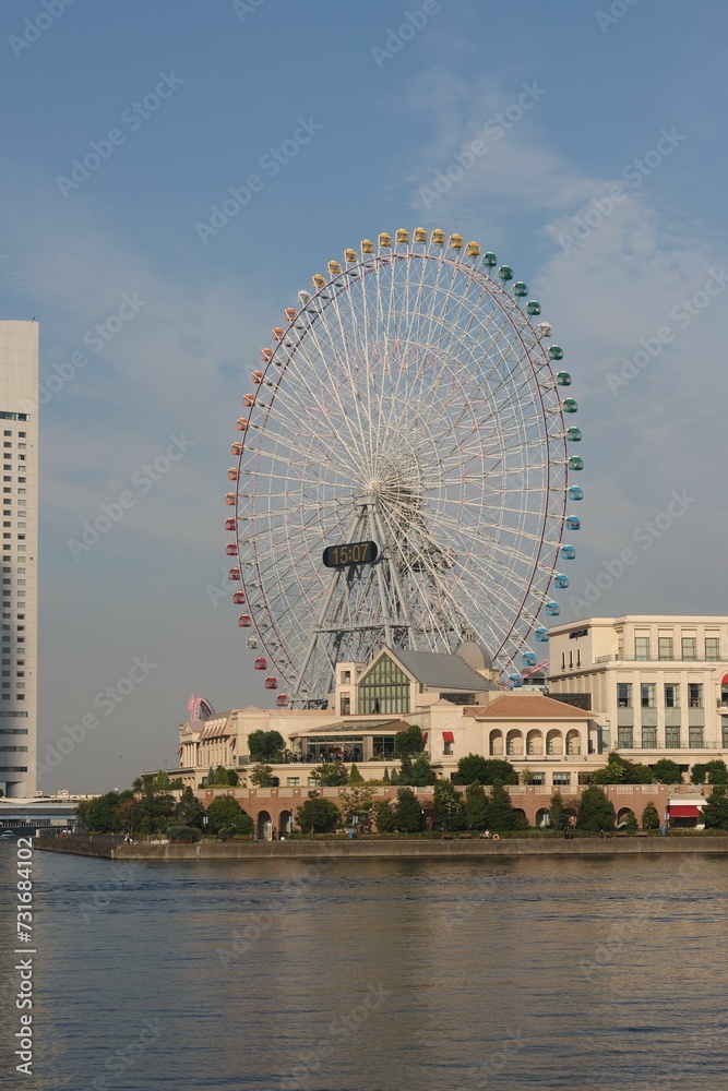 Vertical shot of a large ferris wheel on the shore in Yokohama, Japan
