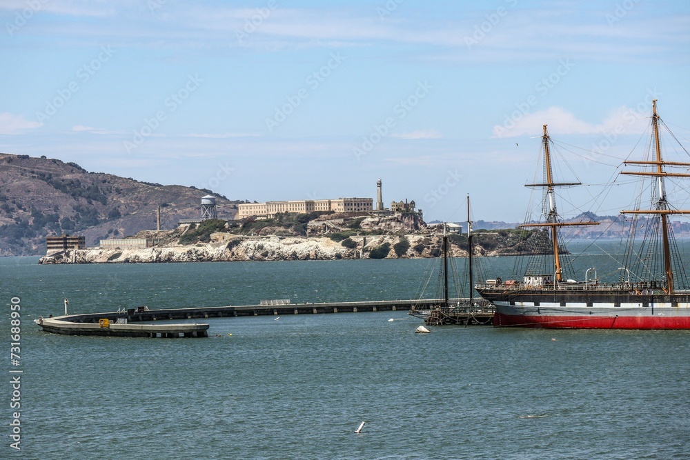 Landscape of Alcatraz Island and sailing ships in San Francisco, California