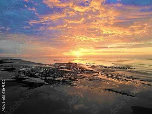 Vibrant sunset over a sandy beach.