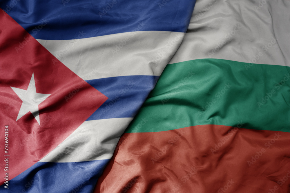big waving national colorful flag of bulgaria and national flag of cuba .