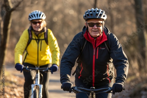 Active senior couple, both 75, enjoying a sunny spring day riding bicycles in sportswear at the park