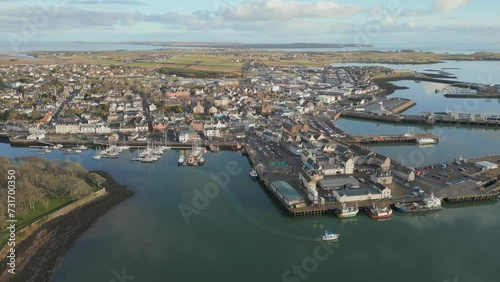 Aerial video of the Stornoway city houses on the sea shore, Main town on Isle of Lewis, Scotland photo