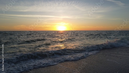 AI generated illustration of the sea waves and beach during a beautiful sunrise in the morning