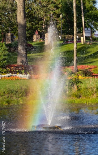 Small fountain with a rainbow arching over it