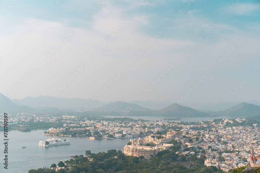 Elevated view of city with lake, landmarks at sunrise. Udaipur, India.