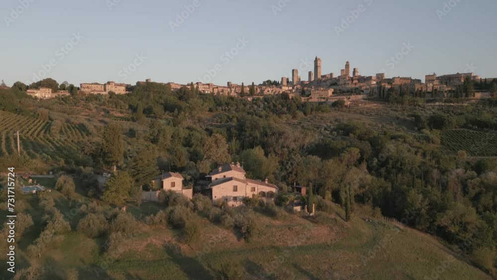 Aerial shot of vineyards and olive groves with San Gimignano in background at sunrise, San Gimignano, Province of Siena, Tuscany Aerial shot of vineyards and olive groves with San Gimignano in background at sunrise, San Gimignano, Province of Siena, Tuscany