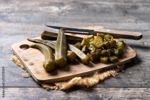 Natural Okra slices on cutting board on wooden table