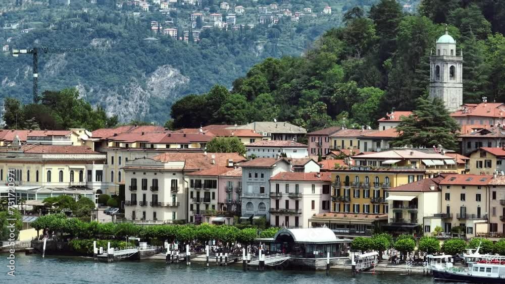 Drone shot over Como lake with view of Bellagio town and forested hill Drone shot over Como lake with view of Bellagio town and forested hill
