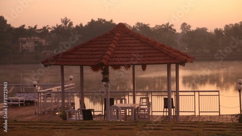 Outdoor gazebo overlooking a tranquil body of water.