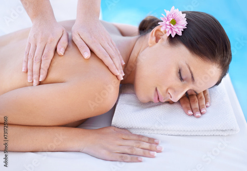 Relax  massage and woman at spa pool with flower for health  wellness and luxury holistic treatment. Self care  peace and girl on table with masseuse for body therapy  sleep and calm hotel service