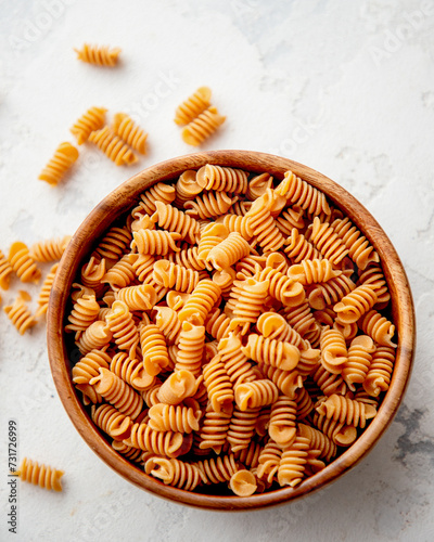 Organic Italian Chickpea Fusilli Pasta in a Wooden Bowl. Gluten-Free, Grain-Free, and Vegan Pasta. Healthy Eating Concept. Top View.