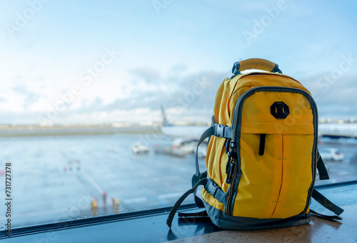 Yellow rucksack in airport. Travel concept. Travel touristic concept. travel light