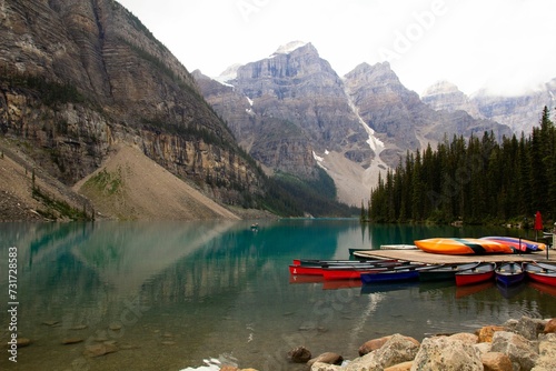 Scenic view of several canoes resting in shallow waters of the Lake Moraine