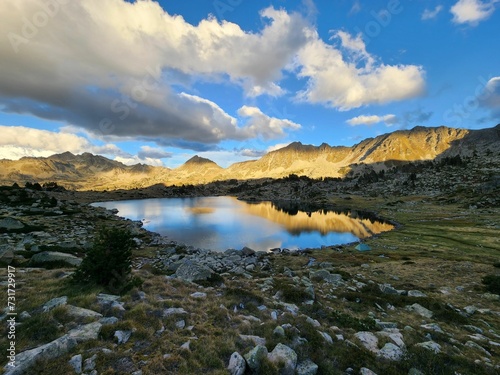 Peaceful scene of a lake in the Pyrenees mountains at sunset