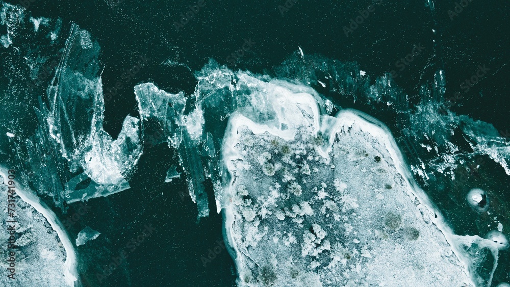 Several ice pieces in a dark and mysterious aquatic environment - obrazy, fototapety, plakaty 