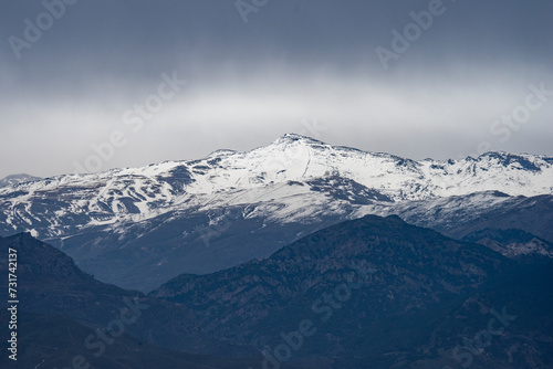 El pico del Veleta destacando entre las montañas de Sierra Nevada en Granada, España	 photo