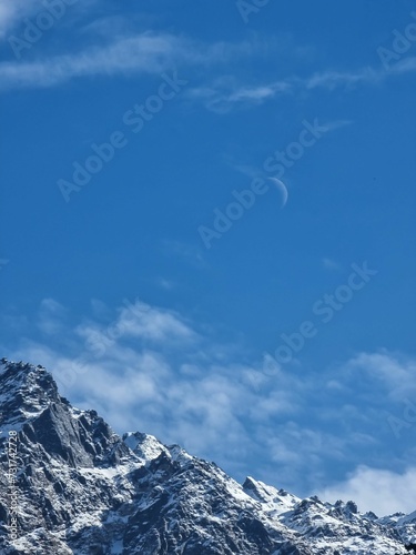 Vertical shot of an awe-inspiring mountain range, with majestic snow-capped peaks rising to the sky © Wirestock