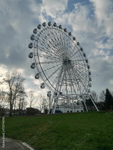 the large wheel has been erected in front of it and is sitting outside