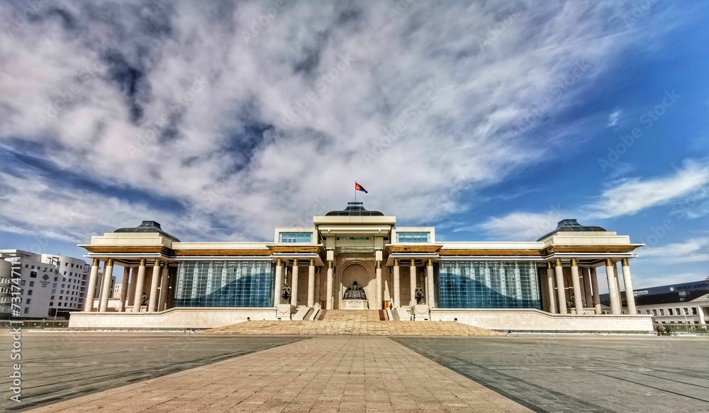 Fototapeta premium Government Palace under a cloudy blue sky in Ulaanbaatar, Mongolia.