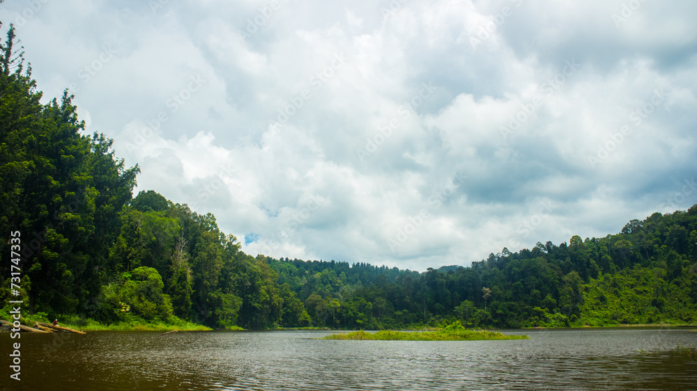 Situ gunung lake in indonesia. Forest lake under cloudy sky