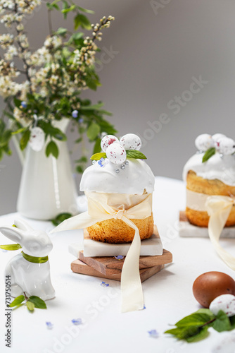 Easter cake and white eggs on a gray  background. beautiful Easter cake surrounded by flowers