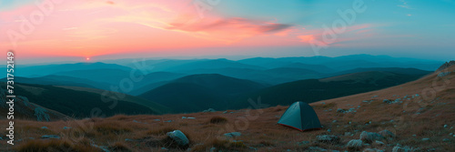 camping tent high in the mountains at sunset 
